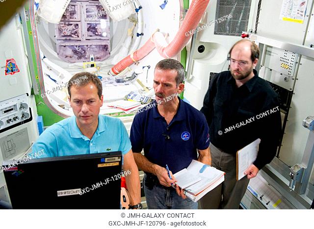 Canadian Space Agency astronaut Chris Hadfield (center), Expedition 34 flight engineer and Expedition 35 commander; and NASA astronaut Tom Marshburn (left)