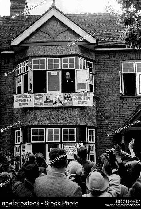 Churchill Meets His Constituents: Mr. Winston Churchill smiling down from an upper window of his central committee rooms in Woodford at a crowd which greeted...