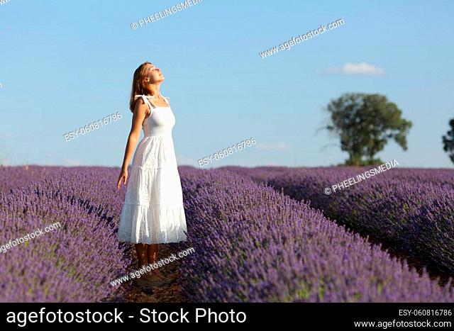 Full body of woman breathing in lavender field