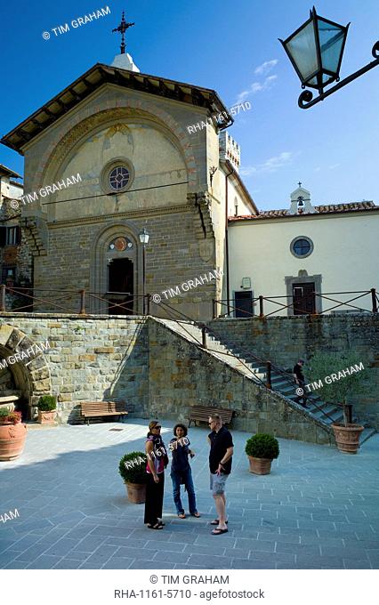Tourists by Tuscan Church of San Niccolo, Chiesa San Niccolo, in Piazza Francesco Ferrucci in Radda-in-Chianti, Tuscany, Italy