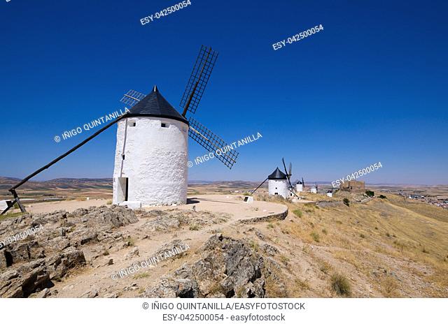 classic wind mills and ancient Castle in Consuegra town (Toledo, Castilla La Mancha, Spain). Built from the Sixteenth to the Nineteenth century