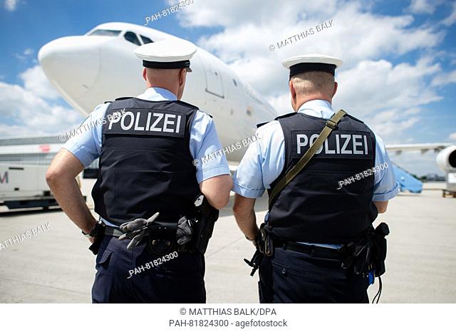 Federal police officers stand in front of an airplane with bulletproof vests and a submachine pistole type Heckler & Koch MP5 in the manoeuvring area at the...