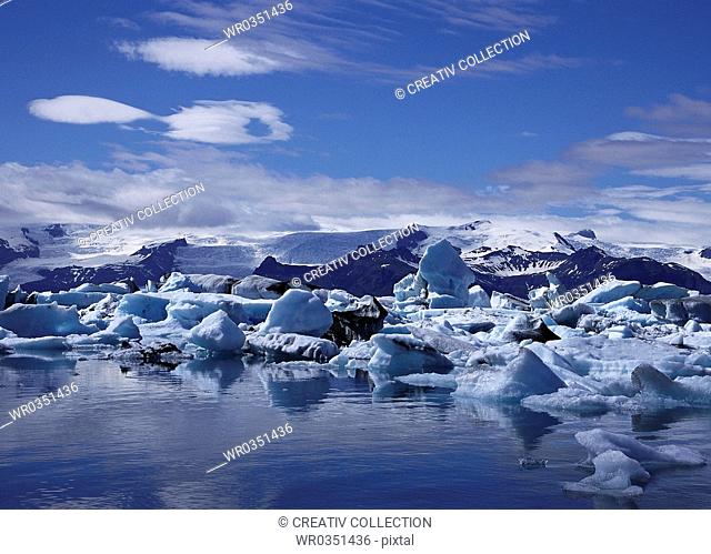 ice blocks next to a shore in an arctic landscape