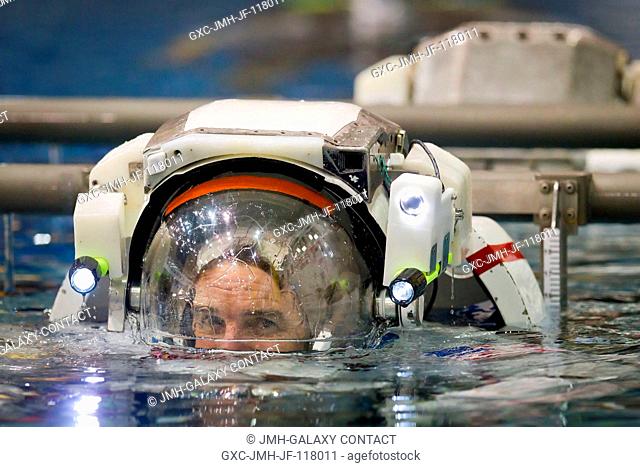 NASA astronaut Rex Walheim, STS-135 mission specialist, is lowered into the water March 22, 2011 to train for a contingency spacewalk in the Neutral Buoyancy...