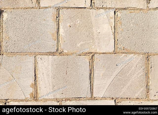 old wall of a building made of large silicate blocks, closeup