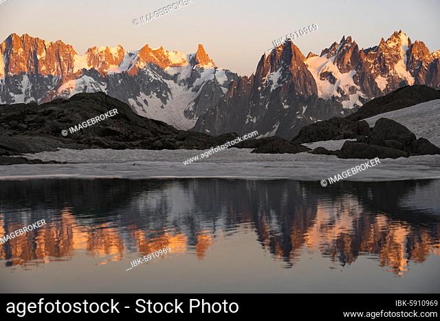 Evening atmosphere with alpenglow, water reflection in Lac Blanc, mountain peaks, Aiguille Verte, Grandes Jorasses, Aiguille du Moine, Mont Blanc