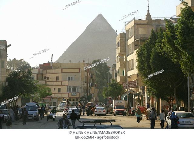 City street contrasted with pyramid in the background, Cairo, Egypt, North Africa, Africa
