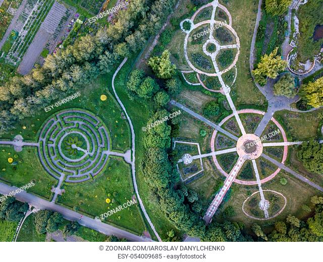 Aerial view of a natural labyrinth in the Botanical garden. Photo from the drone in the evening in summer