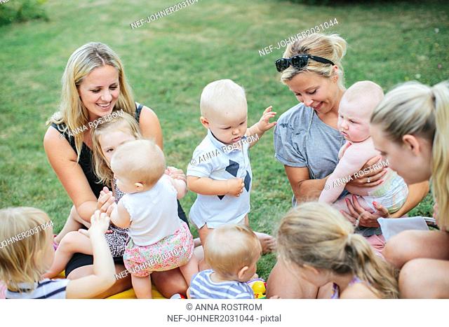 Women with children on grass
