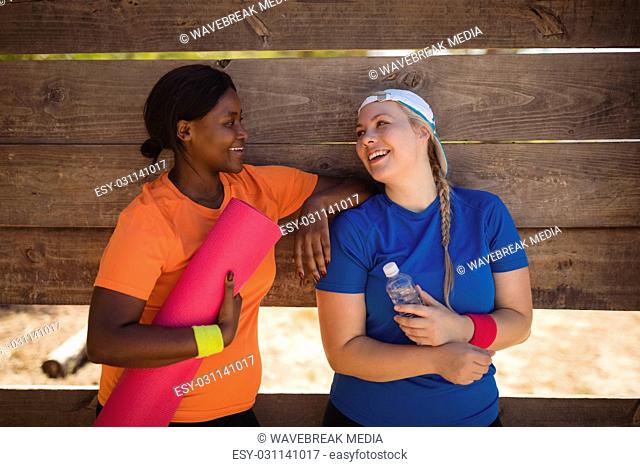 Friends interacting with each other after workout during obstacle course