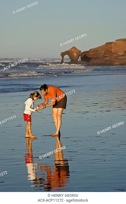 Young woman with daughter at beach at Profitts Point near Darnley, Prince Edward Island, Canada