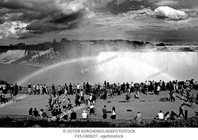 Tourist crowd watching a rainbow at Niagara Falls, Ontario, Canada