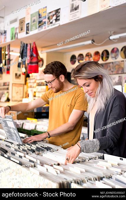 Couple looking at vinyl in record store