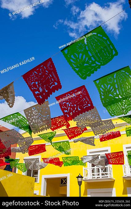 Mexican Papel Picado decorations over a street in San Miguel de Cozumel on Cozumel Island near Cancun in the state of Quintana Roo, Yucatan Peninsula, Mexico