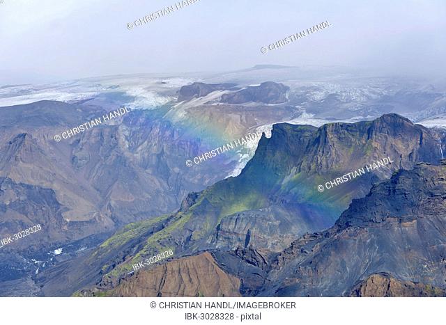 Gorges of Thorsmörk below the Myrdalsjökull glacier with a rainbow, on the long-distance hiking trail from Skógar via Fimmvörðuhals to the Thórsmörk mountain...