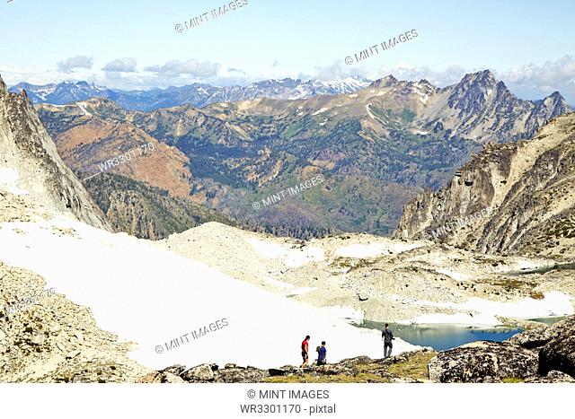 Hikers admiring mountains in remote landscape