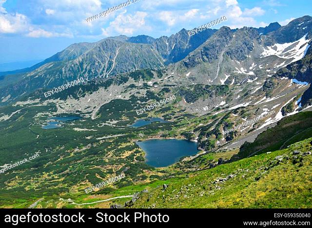 View from mount Kasprov Vrch to the lakes Zielony staw, Kurtkowiec and Dlugi Staw, surrounded by mountains of the High Tatra. Poland