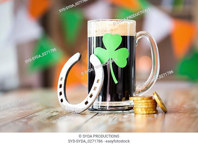 shamrock on glass of beer, horseshoe and coins