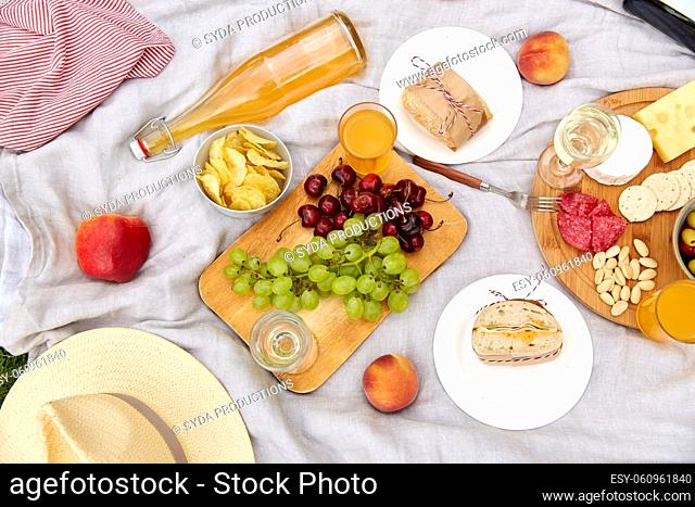 close up of food and drinks on picnic blanket