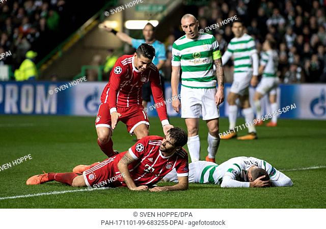 James Rodriguez (L) and scorer Javi Martinez cheer over the 1-2 goal during the Champions League football match between Glasgow's Celtic FC and FC Bayern Munich...