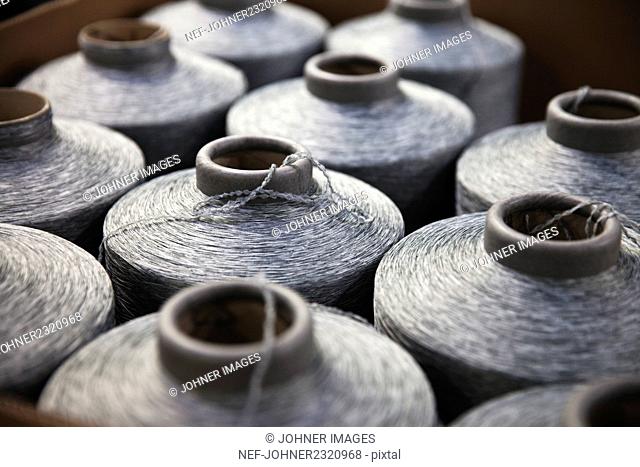 Close-up of silver spools of sewing thread