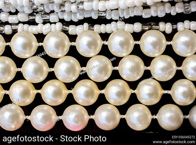 Pearl beads background with many shiny pearls in view