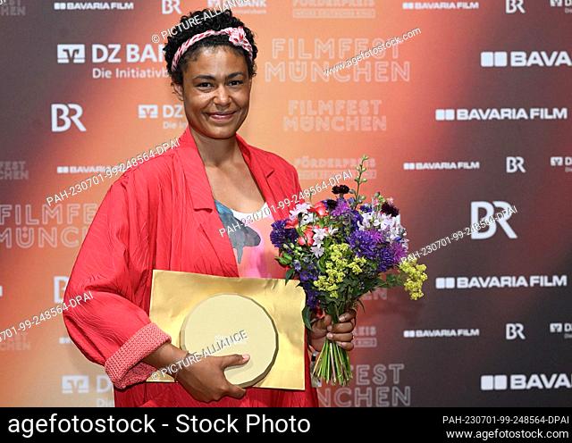 30 June 2023, Bavaria, Munich: The author Merle Grimme stands on the red carpet with her prize at the New German Cinema Award at the Hochschule für Film und...