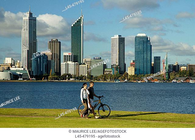 Couple walking along the banks of the Swan River in Perth. Australia. December 2005