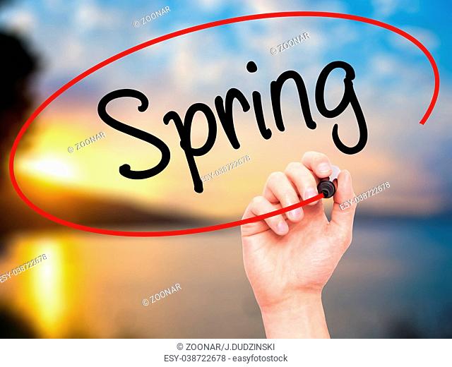 Man Hand writing Spring with black marker on visual screen