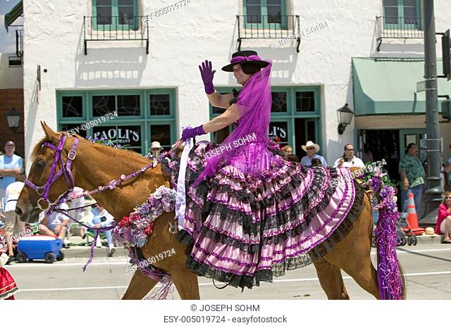 Woman with purple Spanish dress riding horse during opening day parade down State Street, Santa Barbara, CA, Old Spanish Days Fiesta, August 3-7, 2005