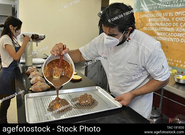 MEXICO CITY, MEXICO - OCTOBER 15: Chef Raul Linares owner of the 'Concheria' bakery, decorates the Pan de muerto (bread of the dead)