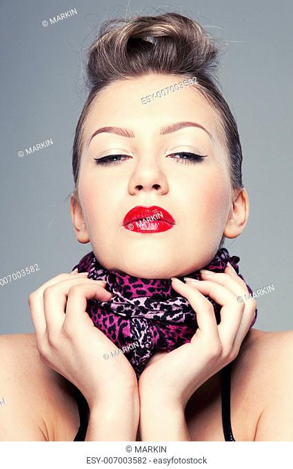 Closeup portrait of beautiful young rock girl on grey background