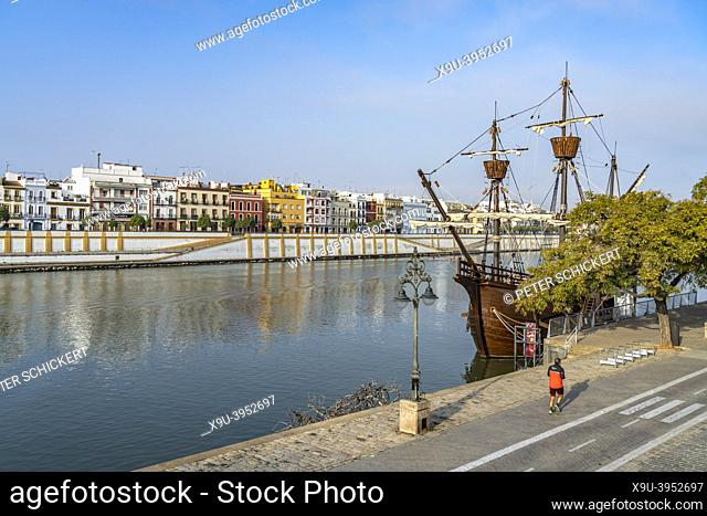 Nao Victoria 500 replica and the colourful houses of the Triana neighborhood at the Guadalquivir river, Seville, Andalusia, Spain