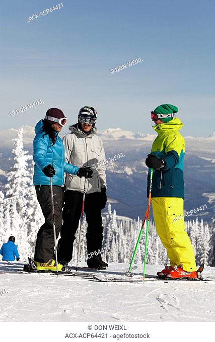 Skiers and snowboarder looking at view from the top of Silver Star Mountain Resort, near Vernon, Okanagan, British Columbia, Canada