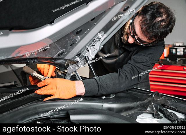 Auto mechanic working and repair on car engine in mechanics garage. Car service. High quality photo