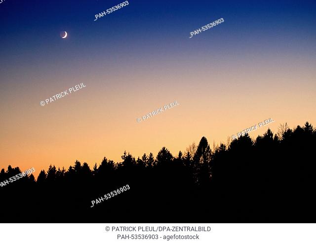 A waxing crescent moon right after sunset in the Bayrischer Wald National Park in Neuschoenau,  Germany, 27 October 2014