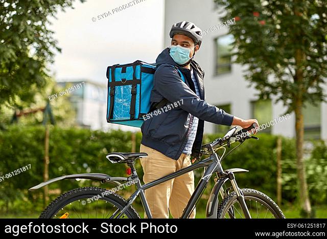 food delivery man in mask with bag and bicycle