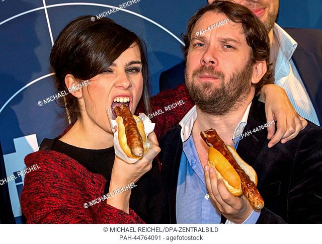 Actors Nora Tschirner and Christian Ulmen pose with sausages during the preview of the 'Tatort' episode 'Fette Hoppe' (lit