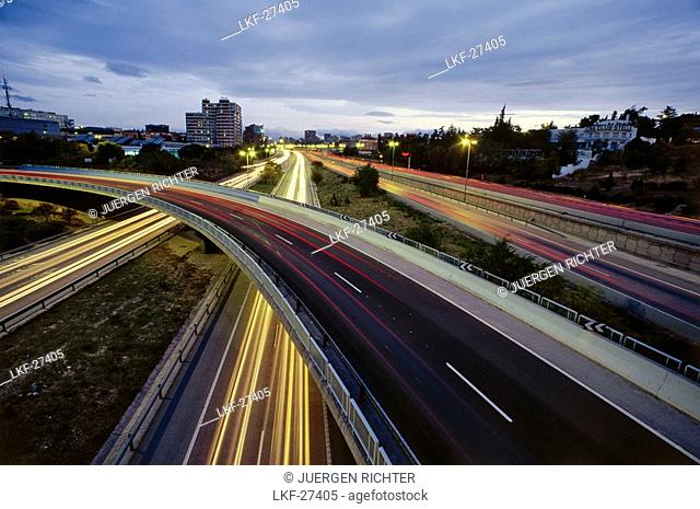 Luminous tracks, blurred motion of automobile headlights, city highway M-30, Madrid, Spain