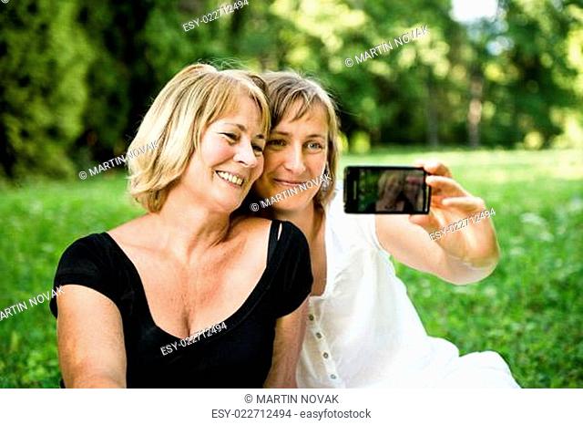 Senior mother with child taking picture