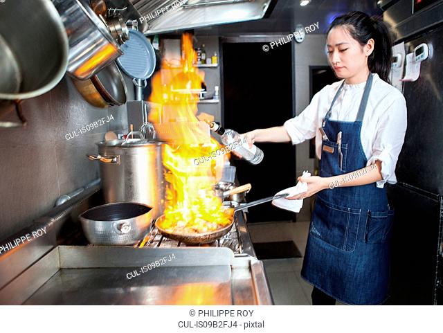 Chef flambeing in commercial kitchen
