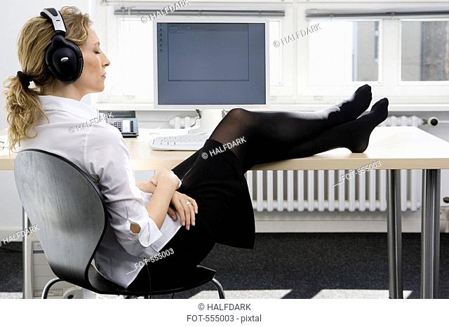 A woman listening to music at work