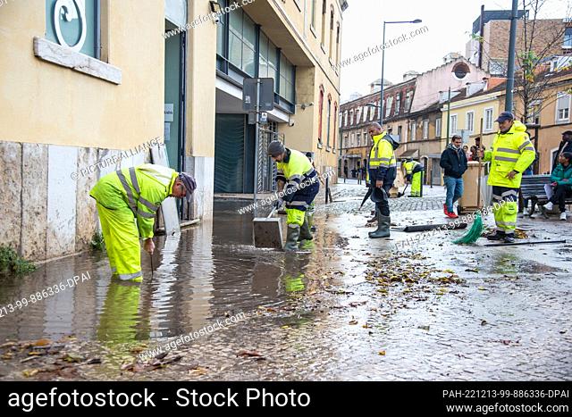 13 December 2022, Portugal, Lissabon: Cleanup in front of the Embassy of Angola in Lisbon after a storm. Heavy rains have caused damage to streets