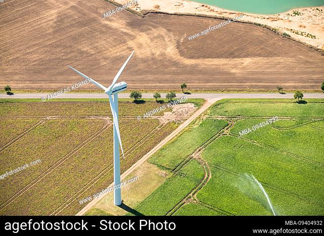 Aerial view of wind turbine on fields at lake
