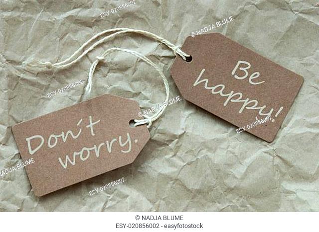 Two Beige Labels With Quote Dont Worry Happy Paper Background