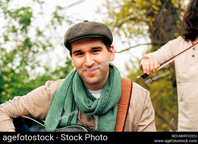 Smiling man wearing scarf and beret