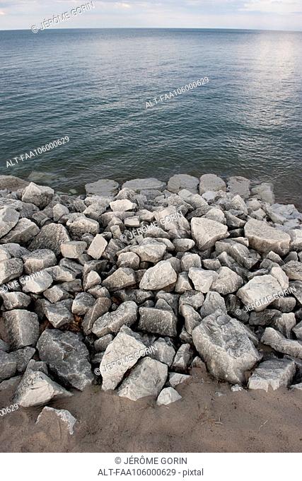 Rocks piled along shore