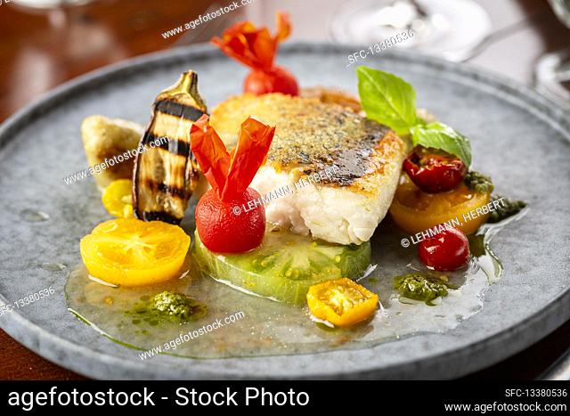 Fried fish with coloured tomatoes