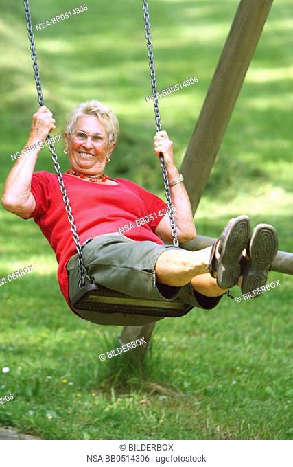 Laughing Senior on swing