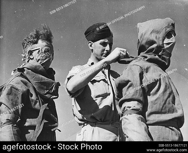 Airmen being helped on with their anti-typhus suits by a member of, the R.A.P. medical branch.The R.A.F. medical staff of the Evacuation Centres dealing with...